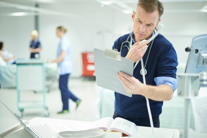A doctor is visibly stressed and working inefficiently due to a lack of process automation.