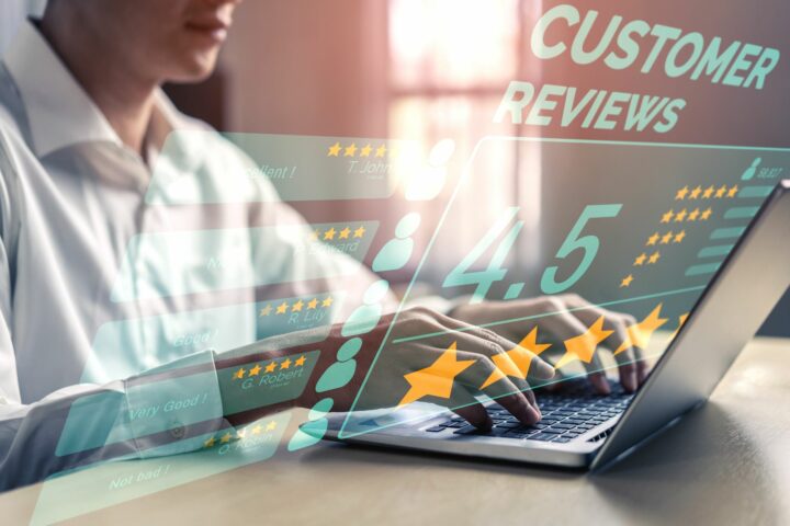 A physician sits at a table reading online patient reviews, practicing reputation management for his hospital.